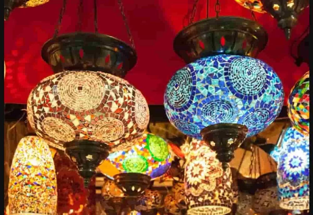 Various traditional Turkish lamps with stained glass and intricate designs hanging with three-leg chains. Securing hanging art installations like this is essential to prevent accidents.