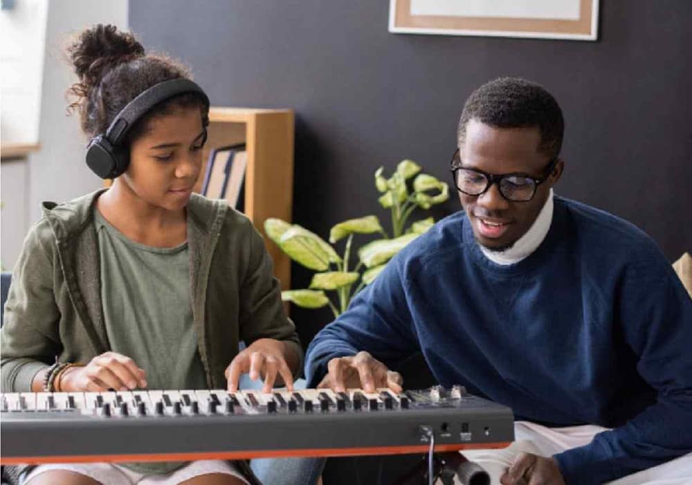 Student listens to her instructor. Here are some tips you need to become a better musician