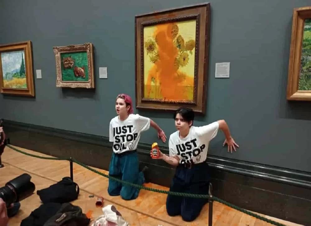 Just Stop Oil activists at the super-glued themselves to the wall after throwing soup on Vincent van Gogh Sunflowers at the National Gallery