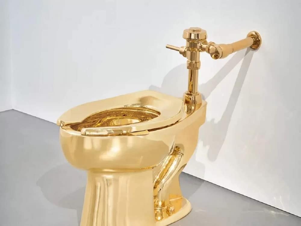 Maurizio Cattelan America golden toilet made from solid gold goes to auction.