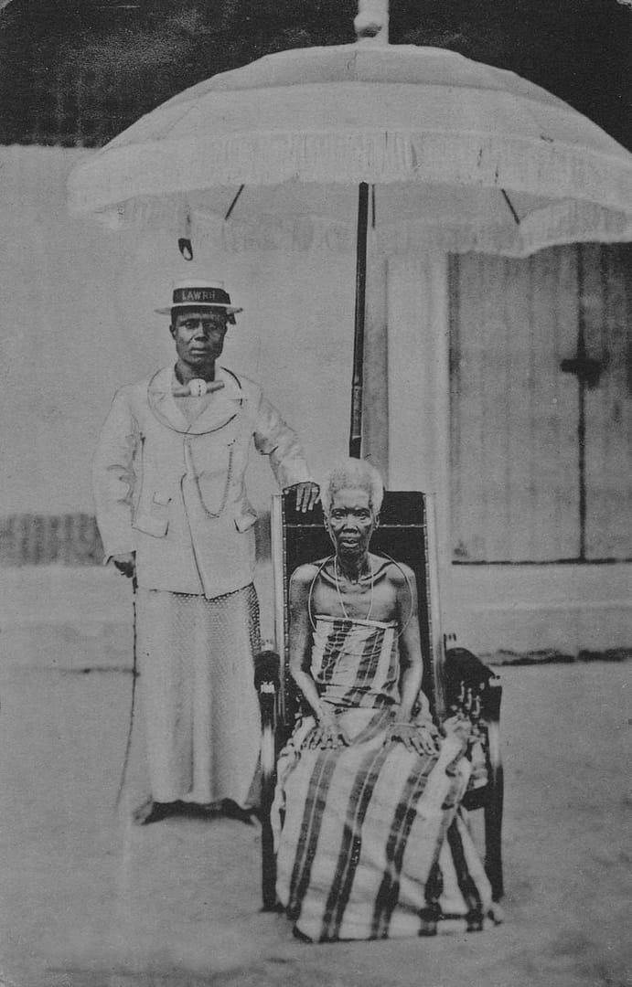A black and white photograph a man and his wife under the queens umbrella shows how photographers capture the culture of Nigeria and record history