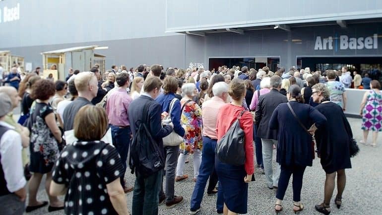 Image: Artists, collectors, galleries and art lovers outside Art Basel in Basel wait to get in to see contemporary art-News