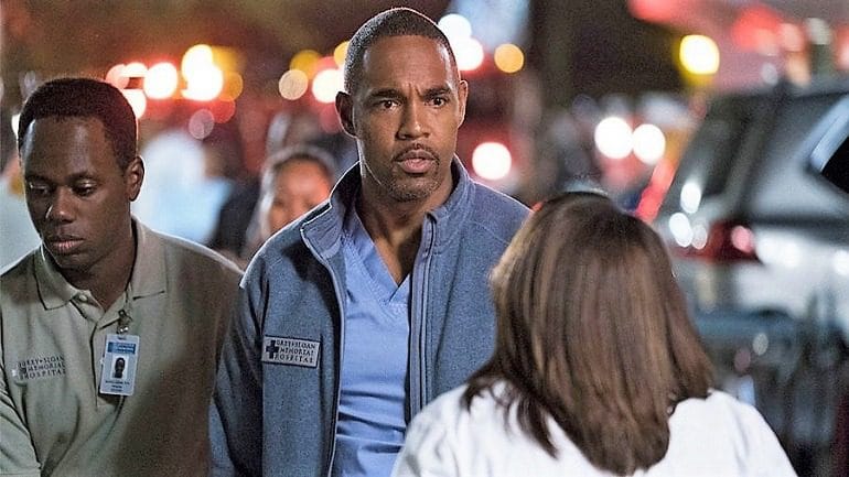 Image: Jason George with other doctors in Grey's Anatomy season 13 finale, contemplating the risk after a dangerous patient escapes the hospital room