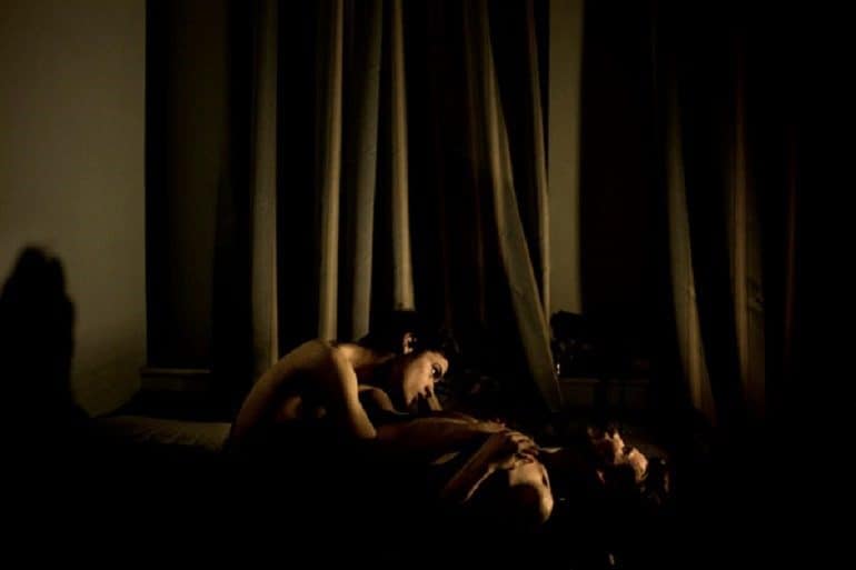 Image: Photograph of Gay couple Jon and Alex during an intimate moment in St Petersburg, Russia by Danish photographer Mads Nissen