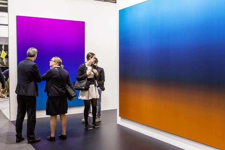 Image: Guests examine paintings and contemporary art at Art Basel in Basel put on display by galleries as the art fair opens -News