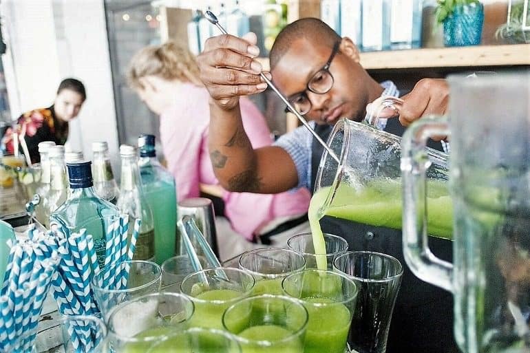 Image: Bartender pours The Godfather of Go Go: Go Go Rickey Bombay made from Bombay Sapphire cocktail recipes for guests in Washington DC