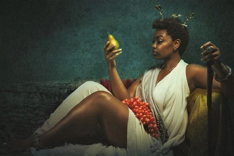 Image: Portrait of a woman in classical style titled Saint Sugar Hill by Alanna Airitam, From the The Golden Age series addressing how black women are represented in Western art