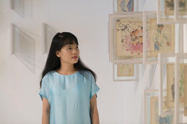Image: Portrait of Thao Nguyen Phan, Winner of the Han Nefkens Foundation – LOOP Barcelona Video Art Award 2018 standing with other artworks