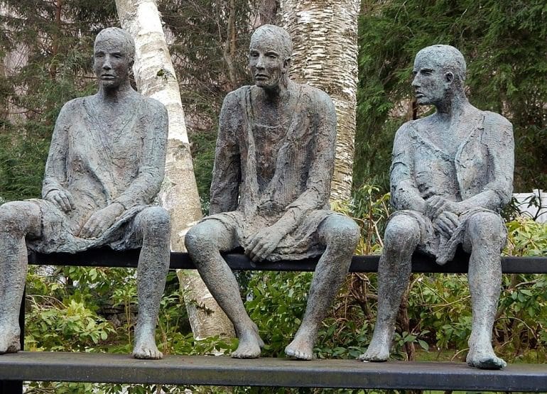 Image: Three Men on a Bench by Hanneke Beaumont is a bronze sculpture that captures human experience