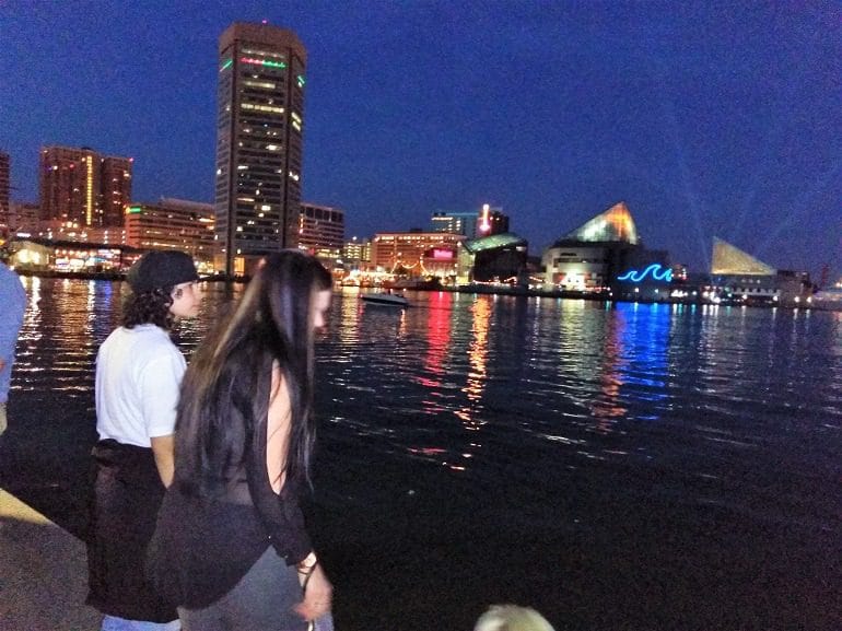 Image: Two people at the Baltimore Inner Harbor, a major destination for people traveling on a tight budget