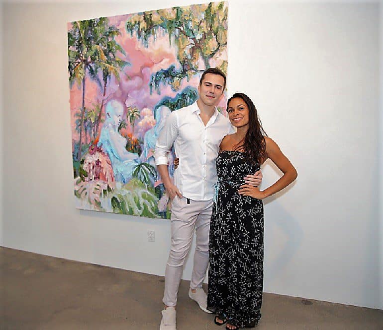 Image: Rosario Dawson and Ivan Alifan in front of a painting at his solo exhibit Escape at the Allouche Gallery