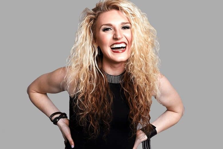 Image: Portrait of Independent artist Paulina Jayne smiling as she lands major sponsorship with Ford Motor Company to promote road safety
