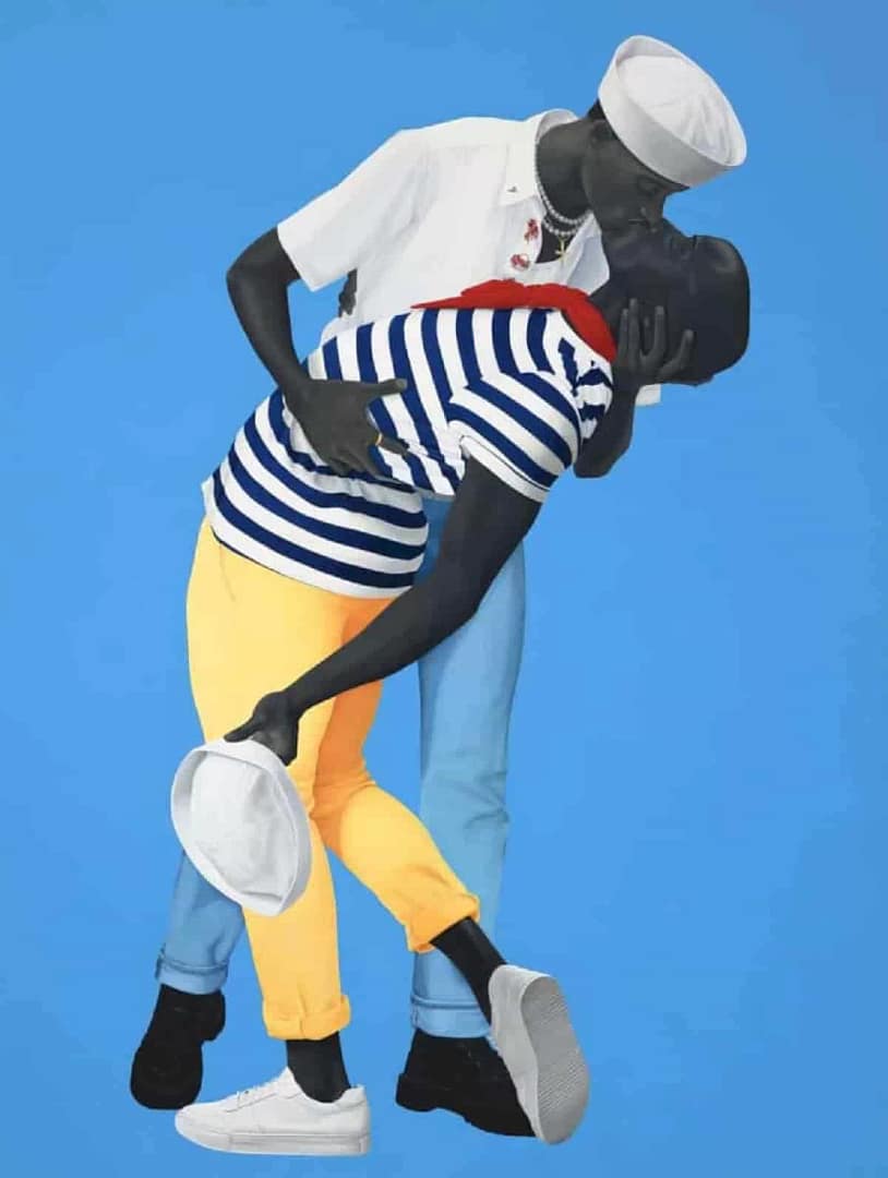 A monumental oil painting by Amy Sherald titled "For love, and for country," featuring two Black men in white naval uniforms embracing in a pose inspired by the iconic V-J Day photograph. The men have grayscale skin and are set against a flat, luminous blue background, emphasizing a sense of quiet dignity and intimacy. The painting is was in Amy Sherald: American Sublime
